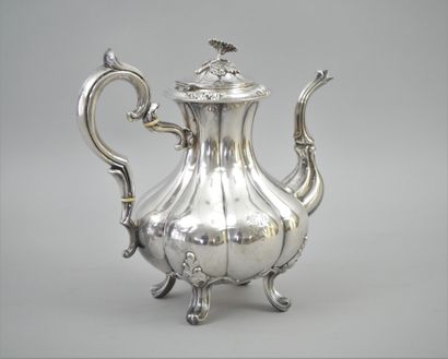 null Silver embossed teapot with a scrolled handle and ivory ferrules; a scrolled...