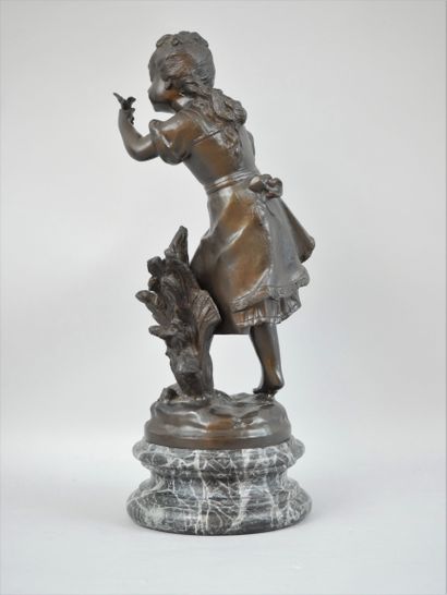 null Augustin MOREAU (1834-1917) Girl with a bird. A bronze proof with brown patina...