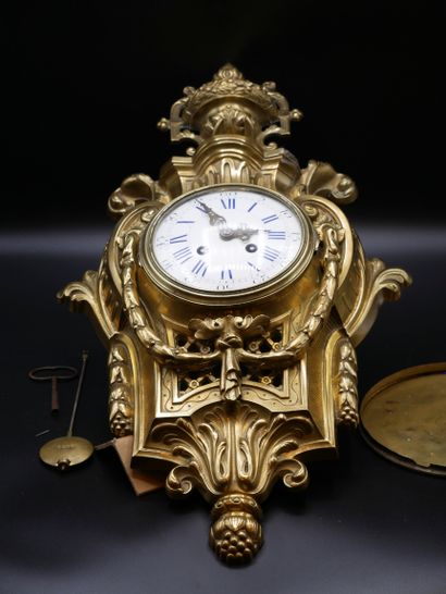 null Gilt bronze cartel with a white enamel dial with blue Roman numerals and black...