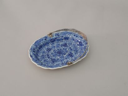null Oval earthenware dish enamelled blue white with decoration of foliage, mounting

with...