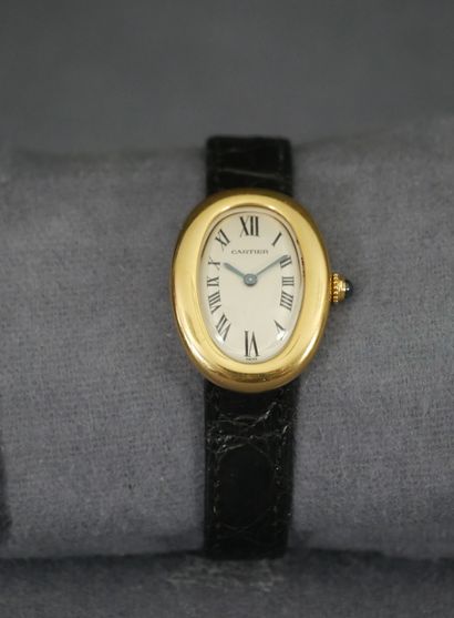 null CARTIER. 18K yellow gold bathtub watch (Diam: 30 x 22 mm), white dial with black...