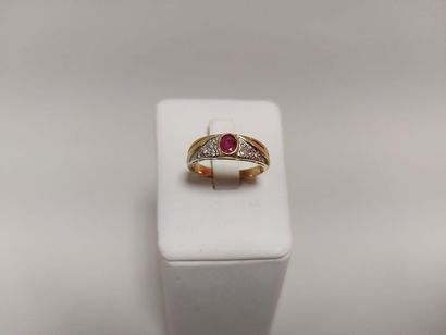 Gold ring set with a small faceted oval ruby...