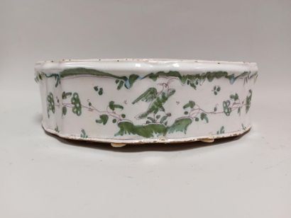 null MOUSTIERS 18th. Earthenware planter with green monochrome decoration of grotesques...