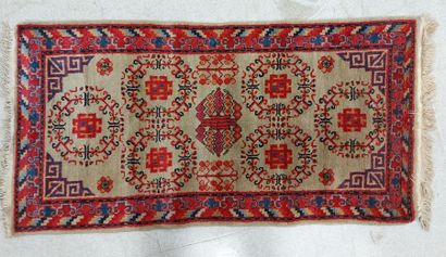 null SAMARKANDE (SINKIANG) RUG in wool decorated with medallions on almond green...