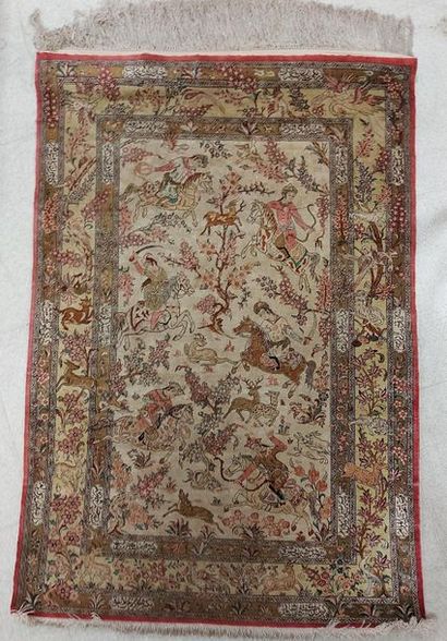 null GHOUM (IRAN) silk rug with hunting scene on beige background. 152 x 104 cm....