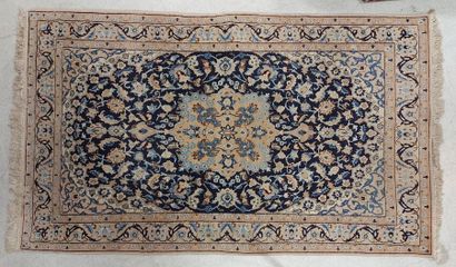 null NAÏM RUG (Iran) in wool with medallion decoration on a blue background. 212...