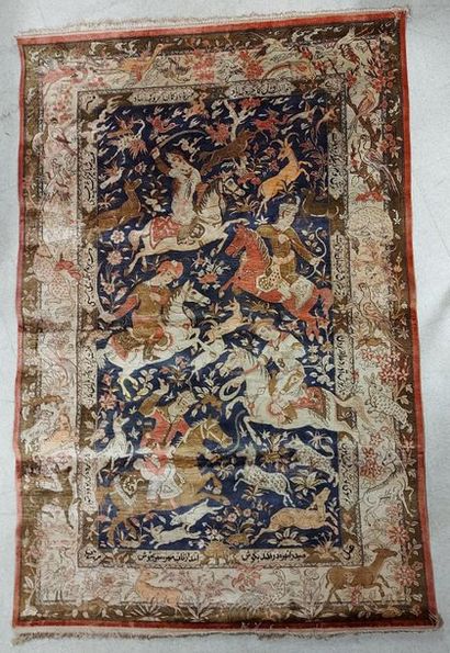 null GHOUM (IRAN) silk rug with hunting decoration on a midnight blue background....