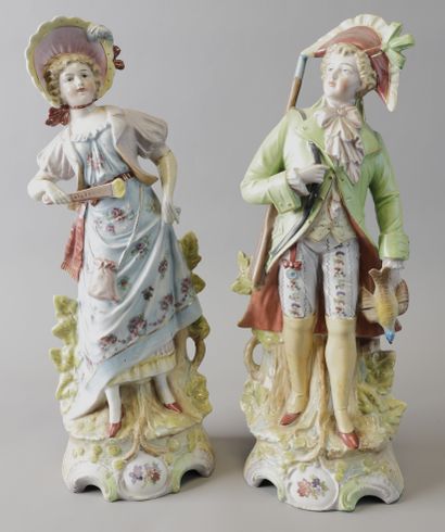 Pair of polychrome porcelain STATUETTES featuring...