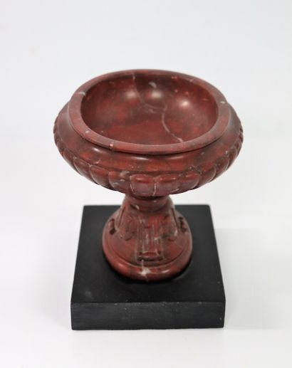 null A red veined marble cup, carved with gadroons, acanthus leaves and flowers.

It...