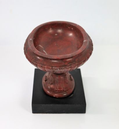 null A red veined marble cup, carved with gadroons, acanthus leaves and flowers.

It...