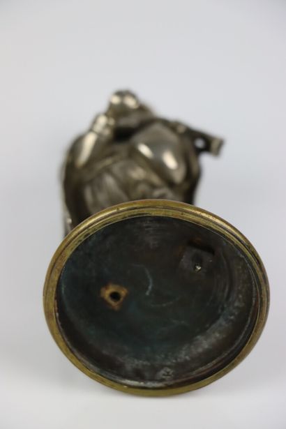 null A partially silvered bronze inkwell or pyrogen, representing a bagpiper.

19th...