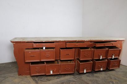 null 
Large rust lacquered wood shop counter, opening with fifteen drawers.




Grey...
