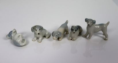 null BING & GROENDAL and others.

Set of nine miniature porcelain statuettes of dogs,...