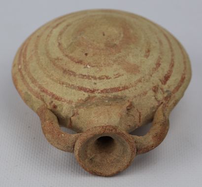 null Antique terracotta flask with flattened body and concentric patterns.

H_12.5...