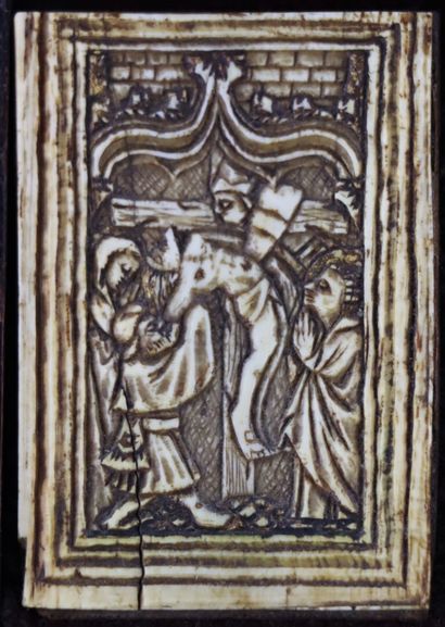 null Two ivory plates in a single wooden frame depicting the descent from the cross...