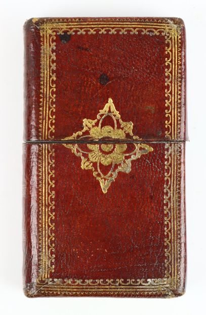 null Leather case simulating a book in red decorated leather, containing two salt...