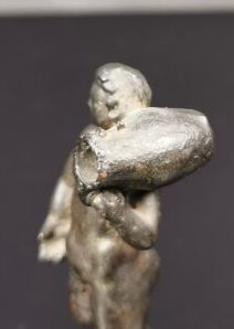 null Small antique bronze with antique patina showing a man holding an amphora on...