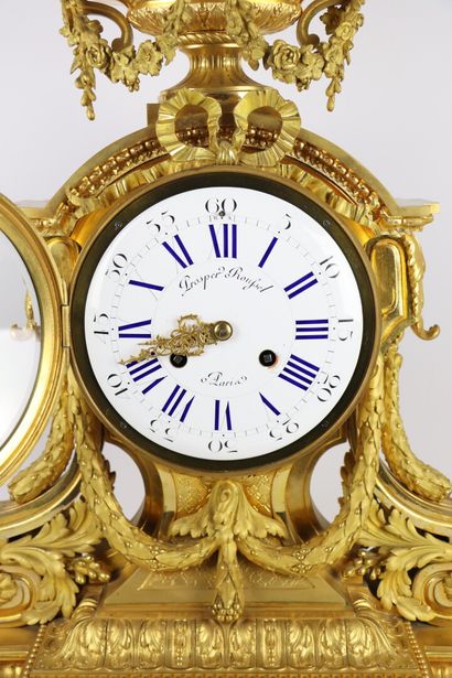 null Important gilt bronze clock decorated with scrolled architecture, laurel garlands...