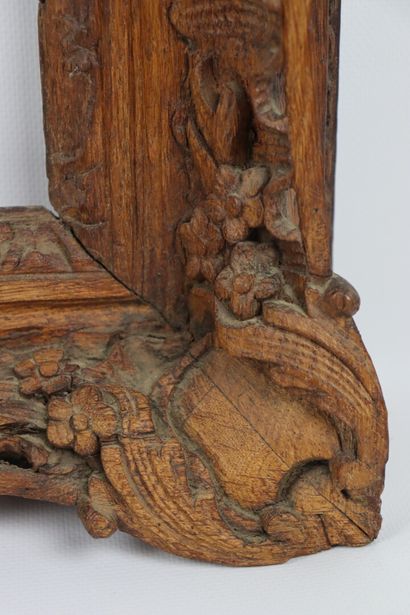 null A pair of carved and molded wood frames with openwork decoration of shells and...