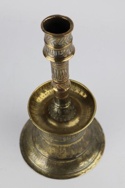 null Brass and silver candlestick, in the style of Mamluk productions.

Ancient work.

H_24...