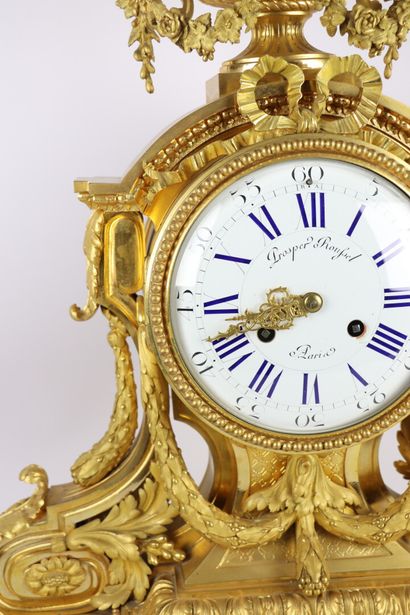 null Important gilt bronze clock decorated with scrolled architecture, laurel garlands...