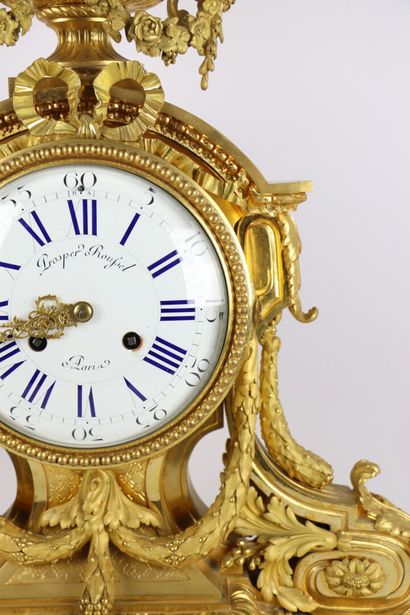 null Important gilt bronze clock decorated with scrolled architecture, laurel garlands...