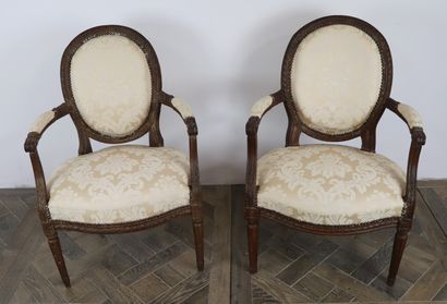 null Two beechwood medallion back armchairs molded and carved with flutes and leaves.

Louis...