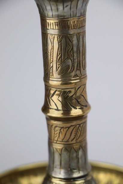 null Brass and silver candlestick, in the style of Mamluk productions.

Ancient work.

H_24...