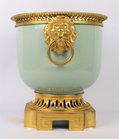 null A celadon porcelain planter, the gilt bronze frame decorated with a frieze of...
