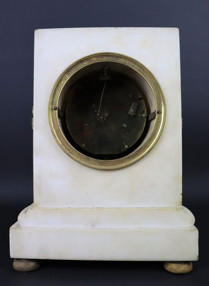 null White marble and bronze clock simulating a column. 

The enamelled dial signed...