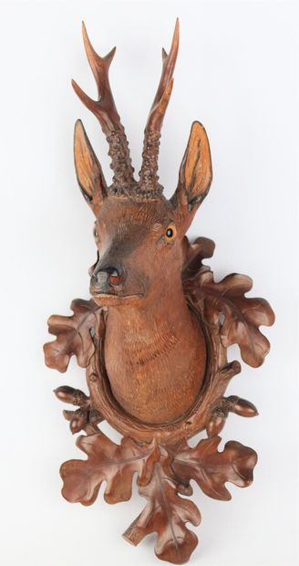 null Carved wooden hunting trophy representing a deer head in a frame decorated with...