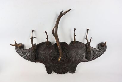 null Carved wood coat rack with scrolls and plants decoration.

The pegs are formed...