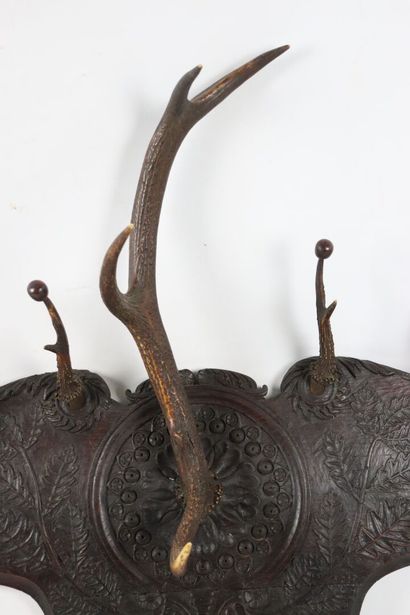 null Carved wood coat rack with scrolls and plants decoration.

The pegs are formed...
