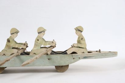 null ETMA.

Jouet de parquet à mécanisme en bois peint figurant un bateau d'aviron...