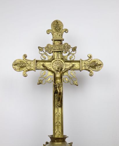 null Altar crucifix in gilt bronze with rich openwork decoration. 
The tripod base...
