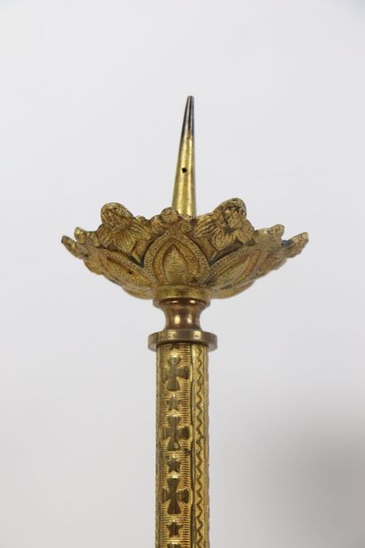 null Pair of gilded bronze candlesticks. 
The shaft ringed with stylized floral decoration....