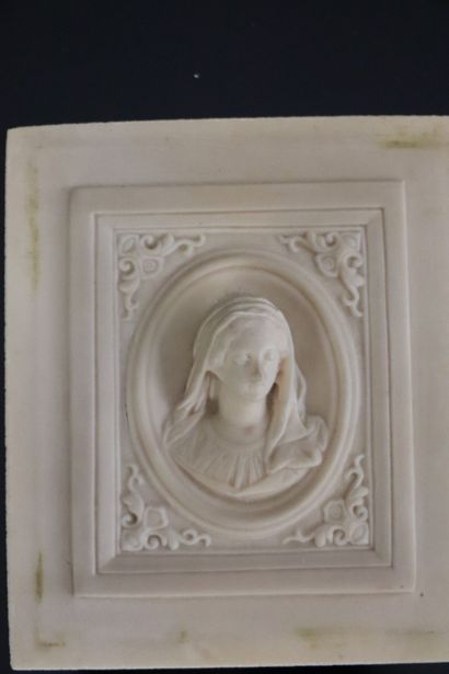 null Compressed stone plaque representing the Virgin in a square medallion.
End of...
