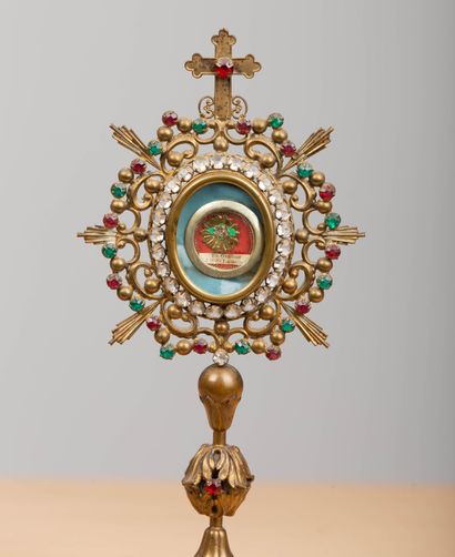 null Two reliquaries on brass and colored glass pedestals.
A small relic of Saint...
