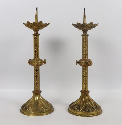 null Pair of gilded bronze candlesticks. 
The shaft ringed with stylized floral decoration....