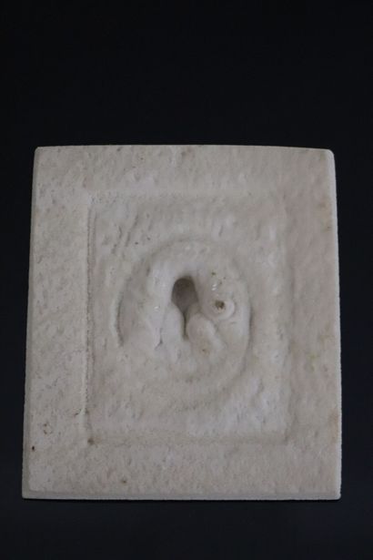 null Compressed stone plaque representing the Virgin in a square medallion.
End of...