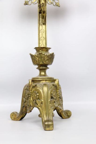 null Altar crucifix in gilt bronze with rich openwork decoration. 
The tripod base...
