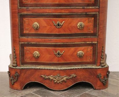 null Semainier in veneered wood with curved front and sides. 
The drawers are inlaid...