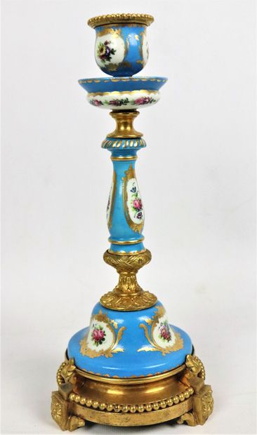 null SEVRES, in the taste of. 
Two porcelain candlesticks on an azure blue background....