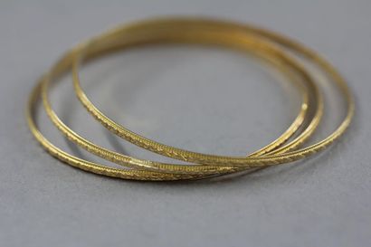 null Trois bracelets rigides en or jaune 18k, travail étranger, pds : 14,2 g.