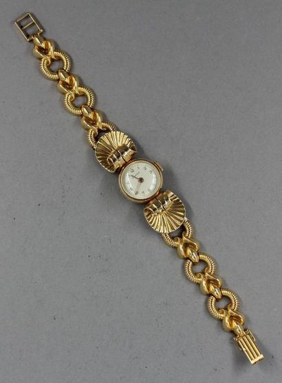 null LAURENS
Bracelet-montre de dame en or jaune 18k, pds brut : 27,7 g.