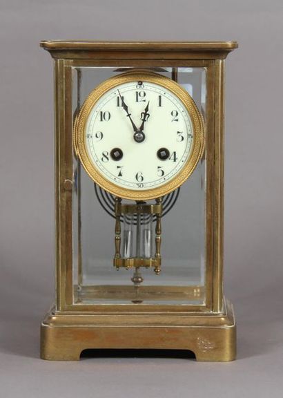 null Cage clock with brass frame and bevelled glasses, the white enamelled dial indicates...