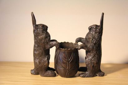 null Bronze vase with brown patina in the shape of rabbits framing a container
21...