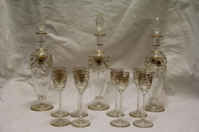null Glass liqueur service with golden garland decoration comprising three carafes...