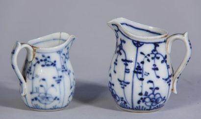 null *Deux pots à lait en porcelaine à décor blanc-bleu, signés