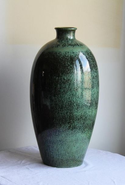 null Large ovoid vase with small straight neck and flared rim in black
spotted green...